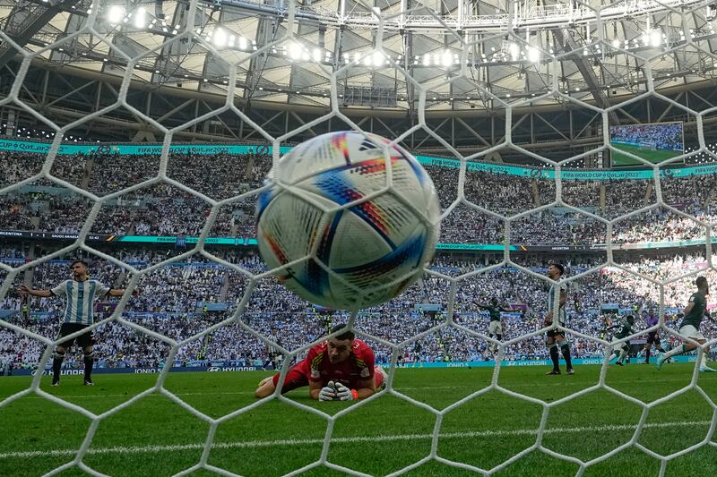 Argentina's goalkeeper Emiliano Martinez can only look on as a shot by Saudi Arabia's Salem Al Dawsari hits the back of his net, in Saudis' 2-1 victory at the Lusail Stadium. AP Photo