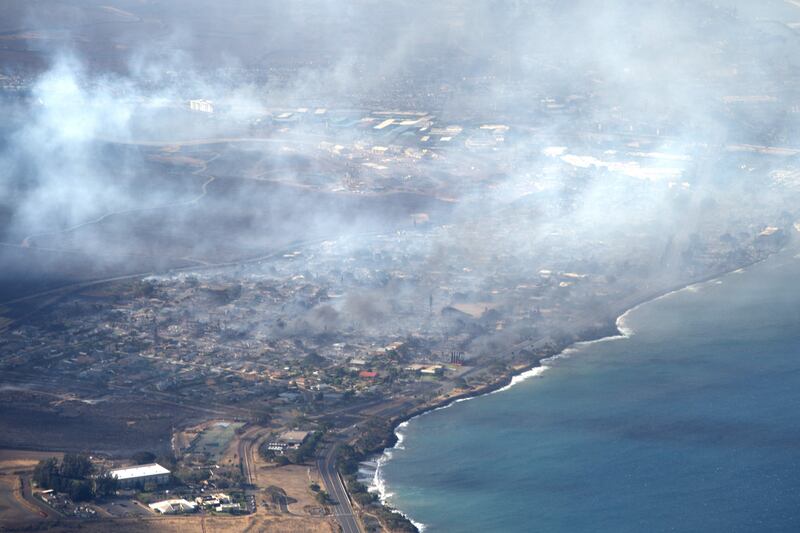 Smoke rises above Lahaina in this handout photo courtesy of Carter Barto via Facebook. AFP