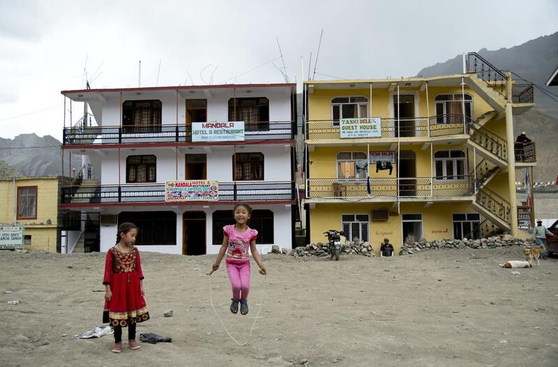 Two girls play in front of newly constructed hotels in Kaza, headquarters of the Spiti Valley. Thomas Cytrynowicz / AP Photo