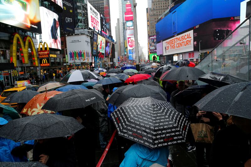 FILE PHOTO: People walk in the rain in Times Square in New York, U.S., May 13, 2017. REUTERS/Eduardo Munoz/File Photo