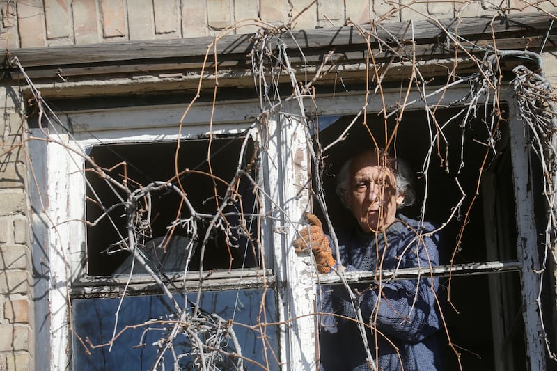 A man inspects a broken window, after shelling carried out by Russian troops in the Ukrainian capital.  Reuters