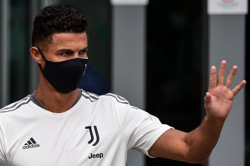 Cristiano Ronaldo waves to fans as he leaves after his medical examination at the Juventus medical centre in Turin, on July 26, 2021.