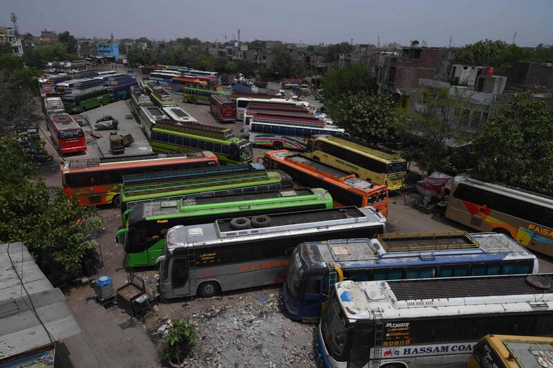 Buses are seen parked before reopening to the public after the government eased a nationwide lockdown in Lahore, Pakistan.  AFP
