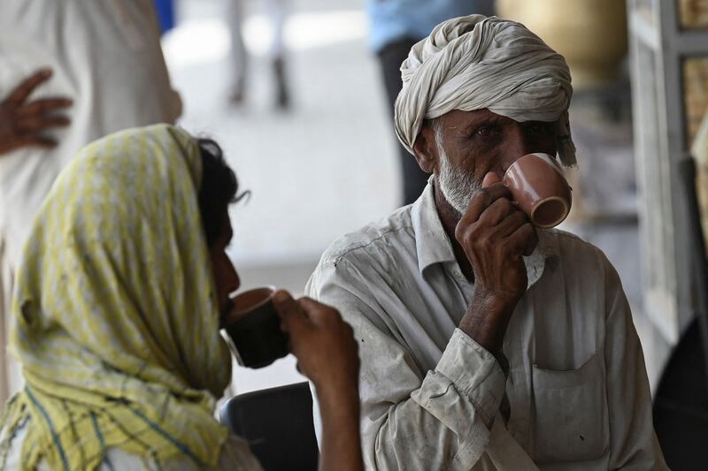 Men drink tea at a roadside restaurant in Islamabad. AFP