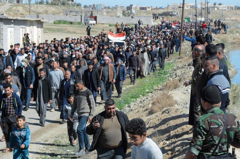 Iraqi mourners pray at the funeral of eight people killed in attacks claimed by ISIS. AFP