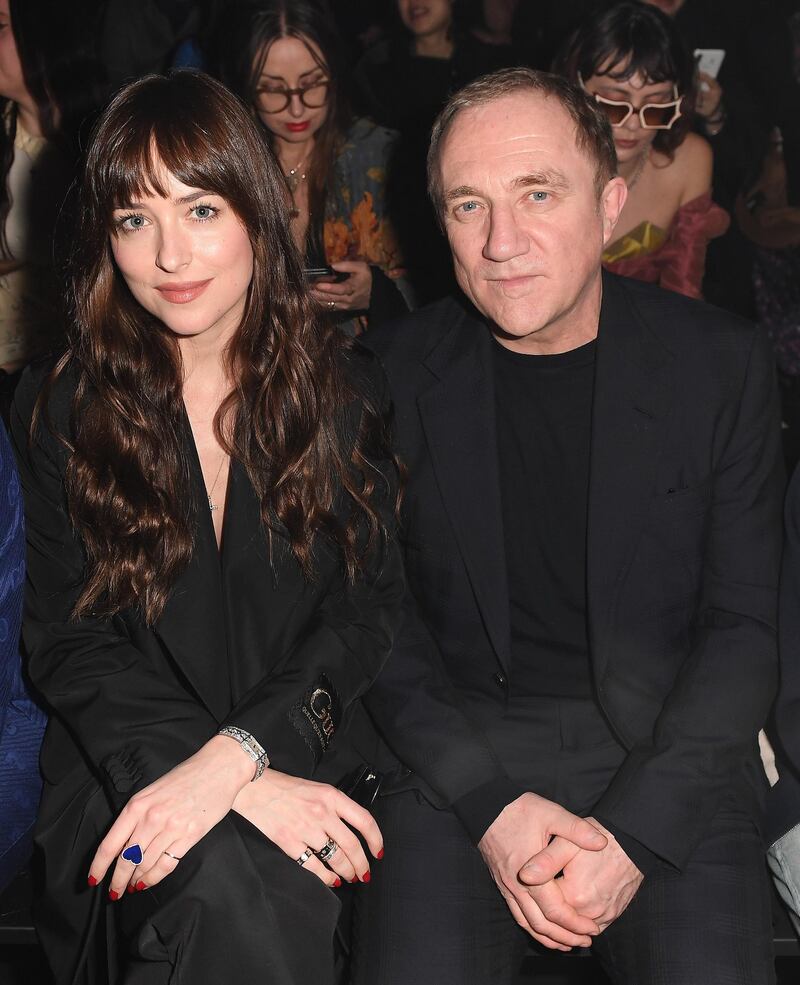 Dakota Johnson and Francois-Henri Pinault are seen on the Gucci front row during Milan Fashion Week on February 19, 2020. Getty Images