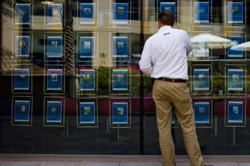 Dubai - March 30, 2010: Customers brows the selection of property ads posted at the Better Homes office in the Gold and Diamonds Souk. Lauren Lancaster /The National

KEY WORDS: Real Estate Agent home homes rent rentals