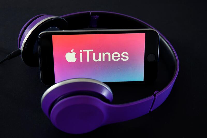 PARIS, FRANCE - JUNE 03: In this photo illustration, the logo of the multimedia application iTunes is displayed next to a headphone on June 03, 2019 in Paris, France. The multimedia application iTunes should disappear tonight at the end of the opening conference of the WWDC held Monday, June 3 in San Jose (California). According to information from several American reference media, the Apple computer group will replace the platform with a trio of independent applications for Mac each responding to a dedicated use: Music, TV and Podcasts. (Photo by Chesnot/Getty Images)