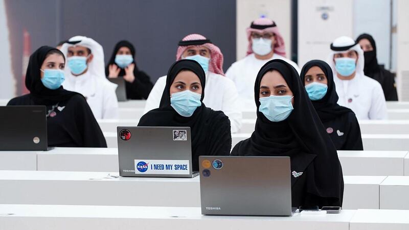 Personnel from the UAE Space Agency control room in Dubai listen in to the broadcast