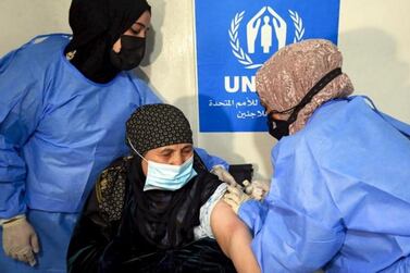 A Syrian refugee is vaccinated at a medical centre in Jordan. Emirates Red Crescent is leading and intensifying efforts to beat coronavirus there and in Iraq. AFP