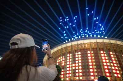 A visitor watches the drone show at the China Pavilion at Expo 2020 Dubai. Photo: Mahmoud Khaled / Expo 2020 Dubai