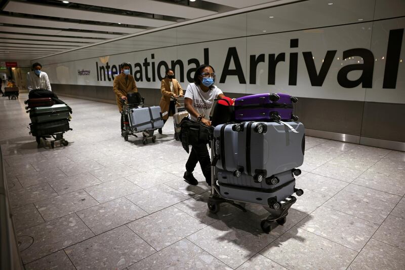 Travellers walk through the arrivals area at Heathrow Airport. Reuters