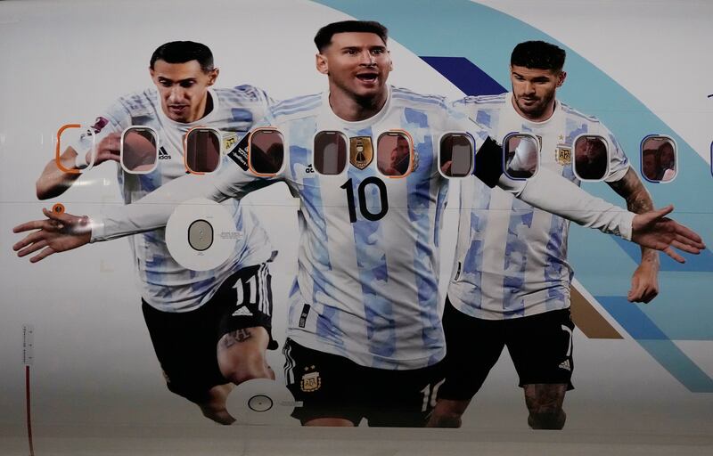 The airplane carrying the Argentina nsquad is painted with pictures of Lionel Messi, center, Angel Di Maria, left, and Rodrigo De Paul arrives at Hamad International airport in Doha, Qatar. AP Photo 