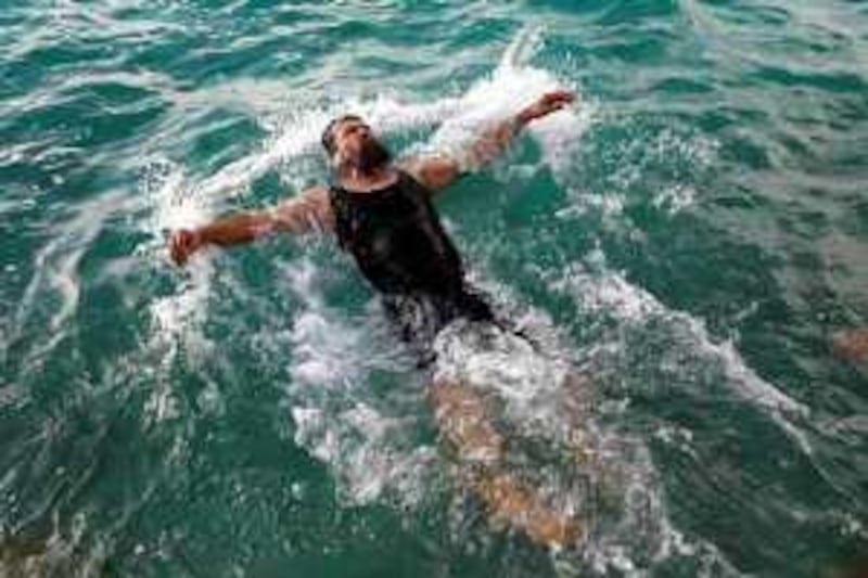 Former Guantanamo detainee Salahidin Abdulahat takes a swim in the Atlantic ocean off the shore near Hamilton, Bermuda, Sunday, June 14, 2009. Abdulahat is among four Chinese ethnic Uighurs who have just been released from U.S. military custody after years in Guantanamo, and are being resettled in Bermuda. (AP Photo/Brennan Linsley) *** Local Caption ***  XBL104_APTOPIX_Bermuda_Guantanamo_Refugees.jpg *** Local Caption ***  XBL104_APTOPIX_Bermuda_Guantanamo_Refugees.jpg