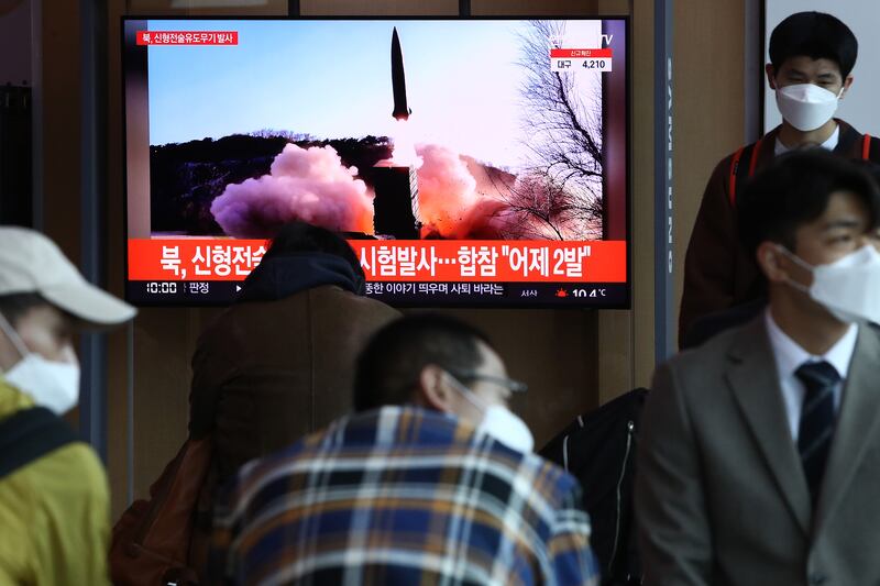 People watch a TV news programme reporting on North Korea test-firing a newly developed tactical guided weapon, at a Seoul train station on April 17. Getty Images