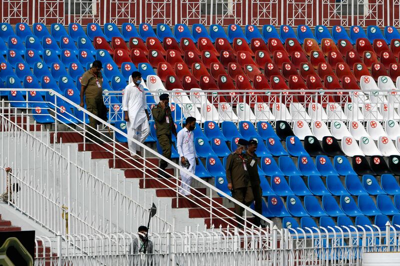 Pakistani policemen walk on the stands of the empty Rawalpindi Cricket Stadium on Friday. AFP