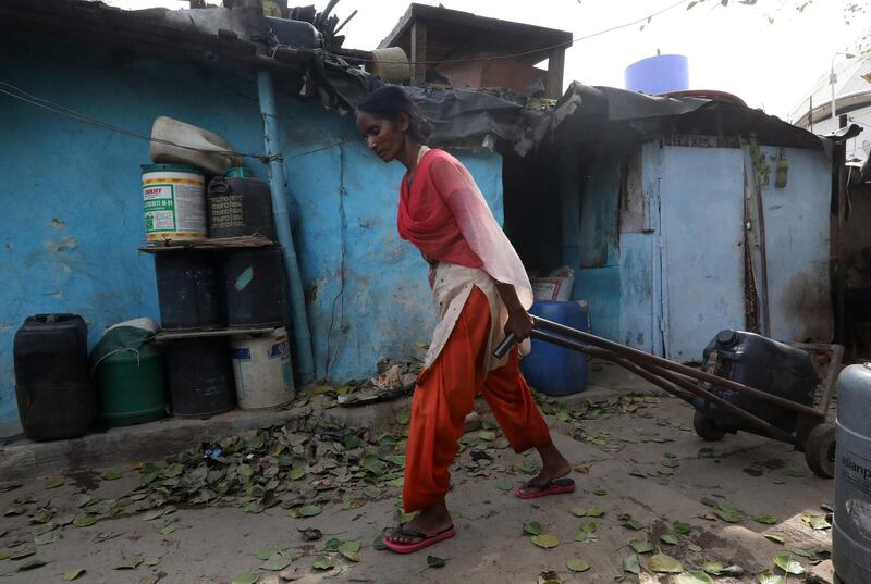 epa06833340 An Indian woman pulls a container after filling up with water from a tanker in Sanjay camp in New Delhi, India, 23 June 2018. National Institution for Transforming India(NITI), a policy think tank of the Government of India has warned that New Delhi will run out of water within two years due to the climate change and population growth. NITI has also warned that Indian states are going to face water crisis by 2020, which includes Major cities like New Delhi and Bangalore. India's worst ever water crisis is expected to adversely impact around 600 million people.  EPA/RAJAT GUPTA