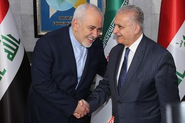 Iraqi Foreign Minister Mohammad Ali al-Hakim (R) receives Iranian Foreign Minister Mohammad Javad Zarif (L) in Baghdad during an official visit. AFP