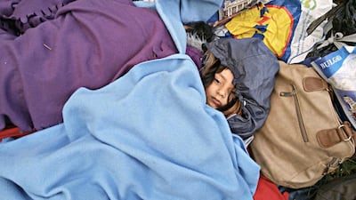 Fazili's daughter Zahra sleeps among their belongings on the Balkan route. Courtesy Old Chilly Pictures