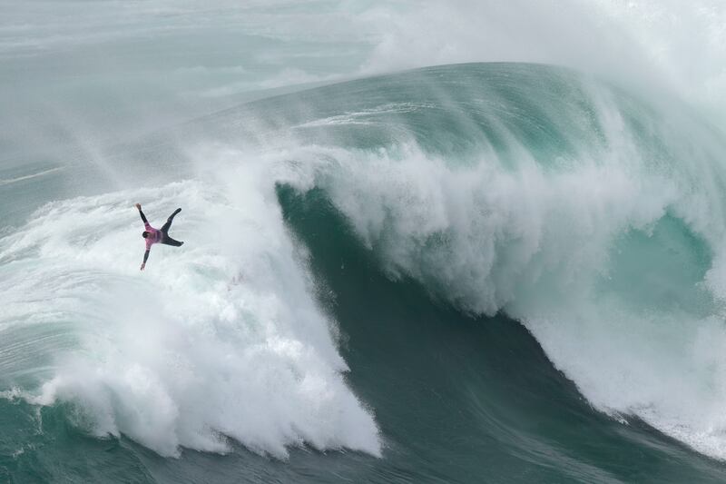 Surfer Eric Rebiere from France goes airborne exiting a wave during the Nazare Tow Challenge big wave surfing competition at Praia do Norte, Nazare, Portugal. AP Photo