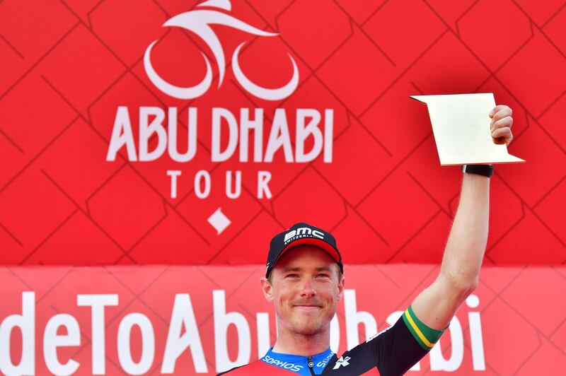 BMC rider Rohan Dennis celebrates on the podium after his victory during the fourth stage of the Abu Dhabi cycling tour in the Emirati capital on February 24, 2018. / AFP PHOTO / GIUSEPPE CACACE