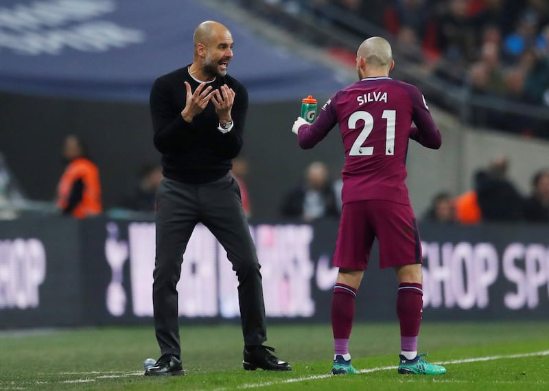 Manchester City's David Silva receives instructions from manager Pep Guardiola. Andrew Couldridge / Reuters
