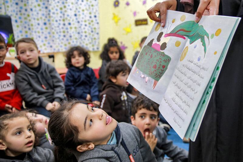 Jordanian teacher Huda Abu al-Khair reads stories to children in a classroom in Amman, from the We Love Reading initiative. AFP