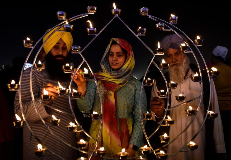 Sikh devotees light candles on the occasion of Bandi Chhor Divas, a Sikh festival coinciding with Diwali, the Hindu festival of Light, at the Golden Temple in Amritsar.  AFP