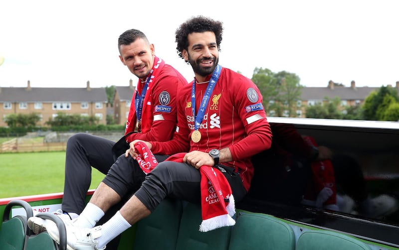 Liverpool's Dejan Lovren (left) and Mohamed Salah (right) on the bus during the Champions League winners parade in Liverpool. PA Wire
