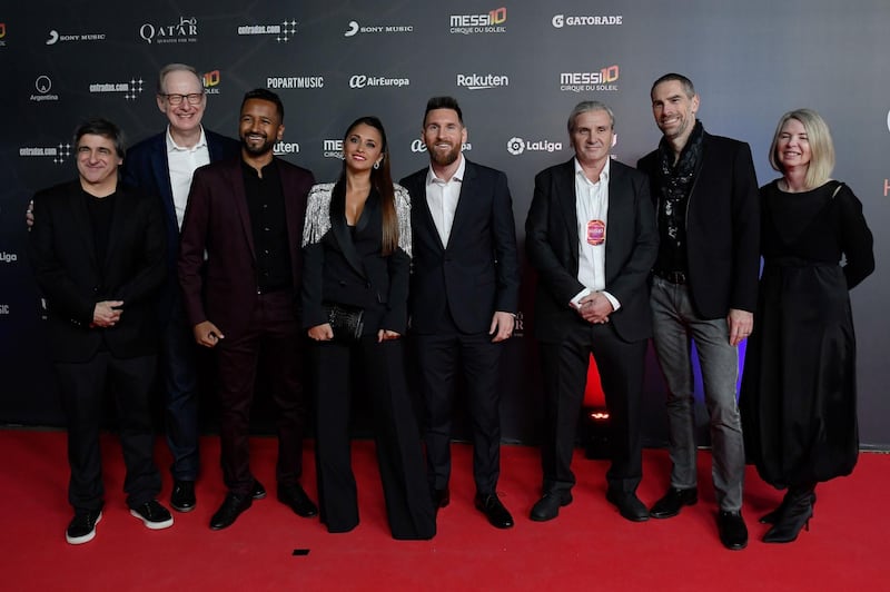 Messi and his wife Antonella pose with director Mukhtar Omar Sharif Mukhtar, third left, and other Cirque du Soleil personnel on the red carpet. AFP