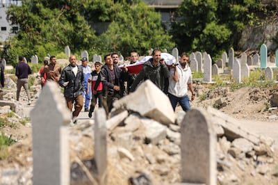 Victims of the Israeli air strike in Gaaza city's Daraj neighbourhood are brought to a cemetery for burial. Anadolu via Getty Images