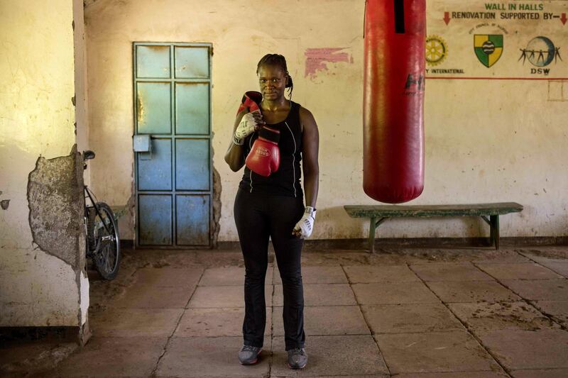 To mark the occasion of International Women's Day on March 8, 2018 AFP presents a series of 45 photos depicting women performing roles or working in professions more traditionally held by men.  More images can be found in www.afpforum.com  Search SLUG  "WOMEN-DAY -PACKAGE". 
Sarah Achieng a 31 year-old professional boxer and sports administrator poses after her training session at Kariobangi social hall gym in Nairobi on February 27, 2018. 
In the ring, battling flames or lifting off into space, women have entered professions generally considered as men's jobs. For International Women's Day, AFP met with women breaking down the barriers of gender-bias in the work world. / AFP PHOTO / Patricia ESTEVE