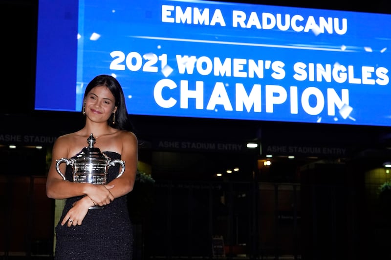 Emma Raducanu, of Britain, poses outside Arthur Ashe Stadium with the championship trophy. AP Photo