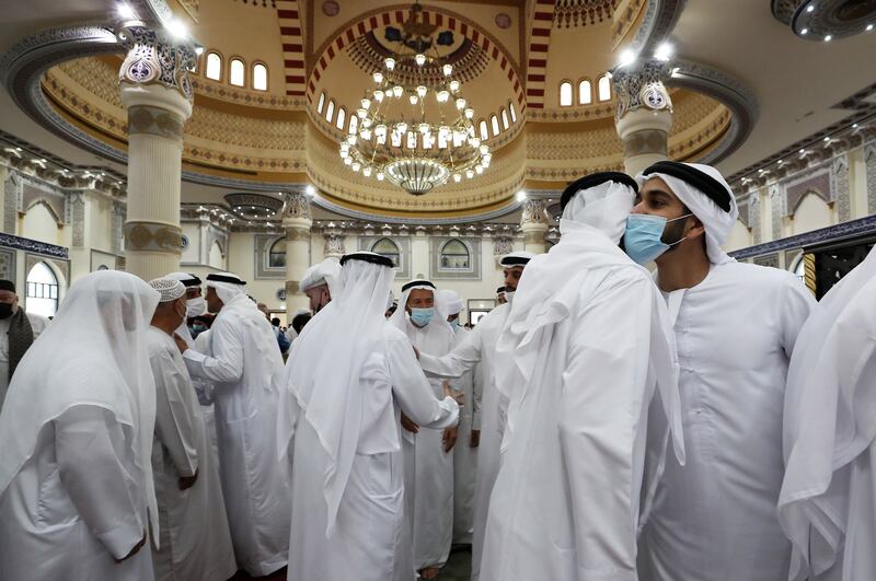 People greeting each other’s after the morning Eid al-Fitr prayers at the Al Farooq Omar Bin Al Khattab Mosque in Dubai. Pawan Singh / The National