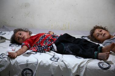 Syrian girls in a makeshift clinic after bombardment on the rebel held area of Tallmannis in Idlib governorate August 20, 2019.  AFP 