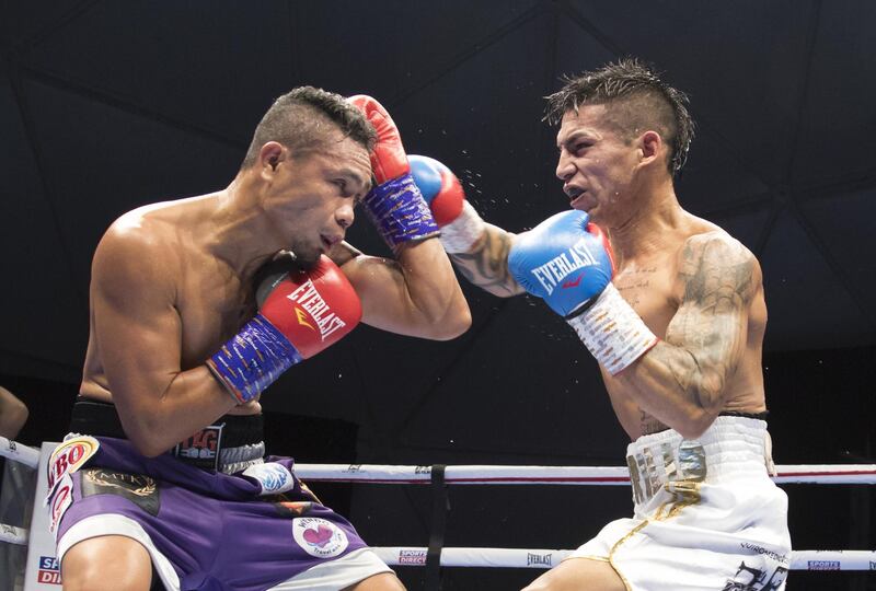 Dubai, United Arab Emirates - Donnie Nietes of the Philippines (left) on a defensive move with  Pablo Carillo of Colombia at the Rotunda, Ceasar's Palace, Bluewaters Island, Dubai.  Leslie Pable for The National