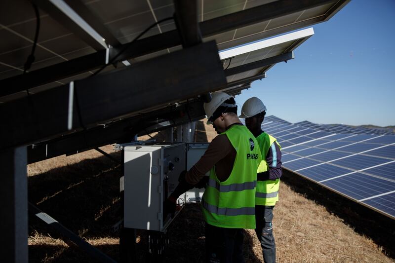 Workers perform checks at the Solara 4 solar park, in Vaqueiros, Portugal. Bloomberg