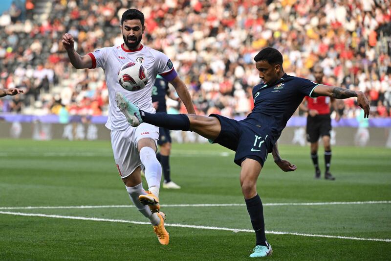 Syria's Omar Khribin challenges Keanu Baccus of Australia for the ball. AFP
