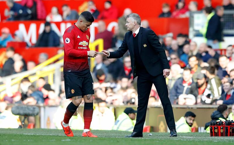 Ole Gunnar Solskjaer, right, passes the aforementioned note to Marcos Rojo. PA via AP