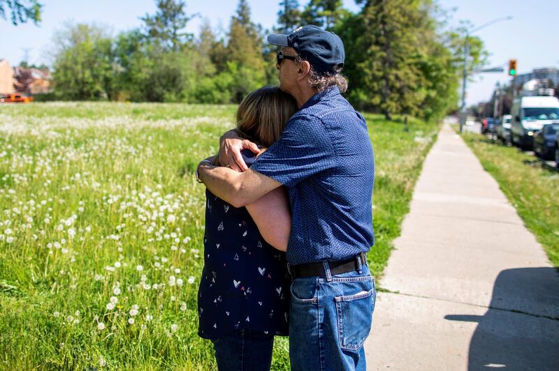 Diane Colangelo, who lost her mother, Patricia Crump to Covid-19, on May 6 is comforted by her husband John Colangelo at Orchard Villa Retirement Residence where several residents died of the coronavirus, in Pickering, Ontario, Canada. Reuters