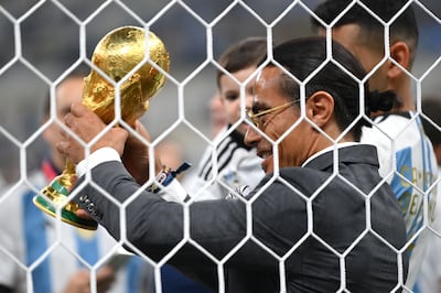 Salt Bae admires the Fifa World Cup trophy after gaining 'undue access' to the pitch after the final between Argentina and France at Lusail Stadium in Qatar. Getty Images