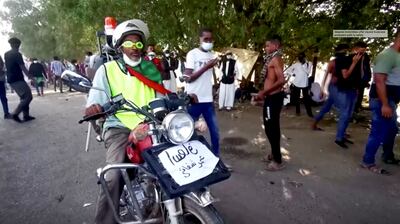 File Photo: A screengrab from a video showing a Sudanese volunteer on a motorbike with a siren and a seat attached to the back that he uses to ferry injured protesters to field hospitals in Khartoum, Sudan. Reuters