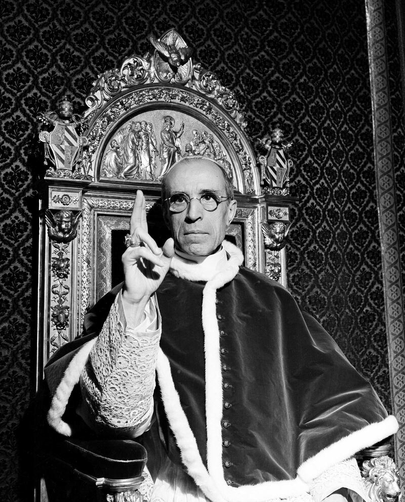 FILE - In this file photo dated Sept. 1945, Pope Pius XII, wearing the ring of St. Peter, raises his right hand in a papal blessing at the Vatican. Pope Francis said Monday, March 4, 2019 he has decided to open up to researchers the Vatican archives on World War II-era Pope Pius XII, who has been accused by Jews of staying silent on the Holocaust.  (AP Photo, File)