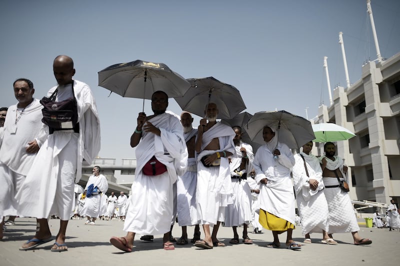 Muslim pilgrims leave after throwing pebbles at pillars during the "Jamarat" ritual, the stoning of Satan, in Mina near the holy city of Mecca, on September 24, 2015. Pilgrims pelt pillars symbolizing the devil with pebbles to show their defiance on the third day of the hajj as Muslims worldwide mark the Eid al-Adha or the Feast of the Sacrifice, marking the end of the hajj pilgrimage to Mecca and commemorating Abraham's willingness to sacrifice his son Ismail on God's command in the holy city of Mecca. AFP PHOTO / MOHAMMED AL-SHAIKH / AFP PHOTO / MOHAMMED AL-SHAIKH