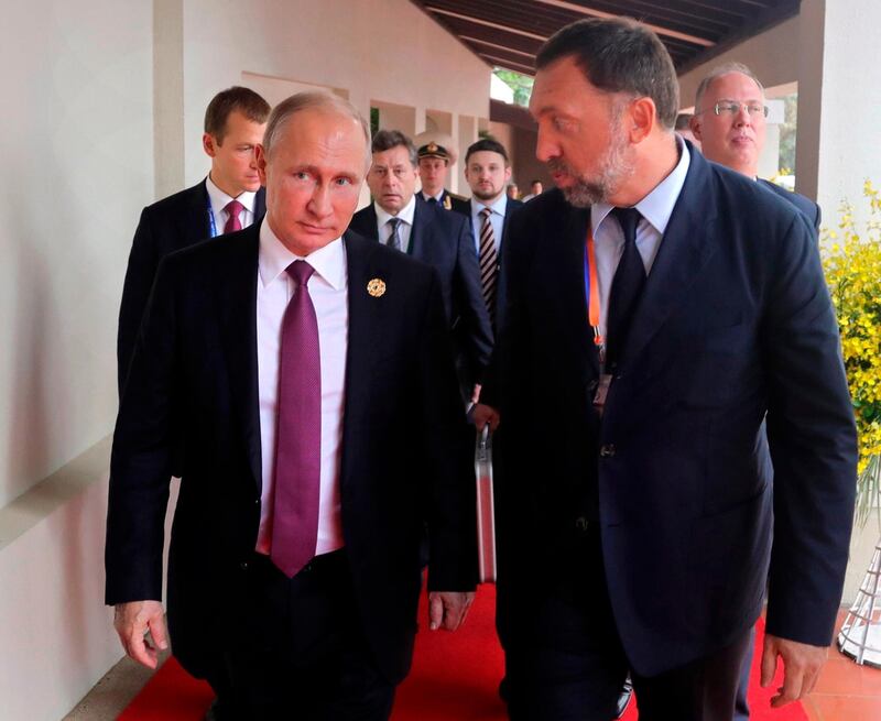 File-This Nov. 10, 2017, file photo shows Russia's President Vladimir Putin, left, and Russian metals magnate Oleg Deripaska, right, walking to attend the APEC Business Advisory Council dialogue in Danang, Vietnam. The United States punished dozens of Russian oligarchs and government officials on Friday, April 6, 2018, with sanctions that took direct aim at President Putin's inner circle, as President Donald Trump's administration tried to show he's not afraid to take tough action against Moscow. Seven Russian tycoons, including aluminum magnate Deripaska, were targeted, along with 17 officials and a dozen Russian companies, the Treasury Department said.  (Mikhail Klimentyev, Sputnik, Kremlin Pool Photo via AP, File)