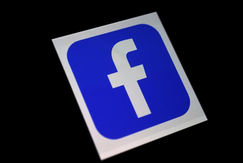 (FILES) In this file illustration photo taken on March 25, 2020 a Facebook App logo is displayed on a smartphone in Arlington, Virginia. Facebook said on August 5, 2020 that it had removed a post from the page of US President Donald Trump over what it called "harmful COVID misinformation." / AFP / Olivier DOULIERY
