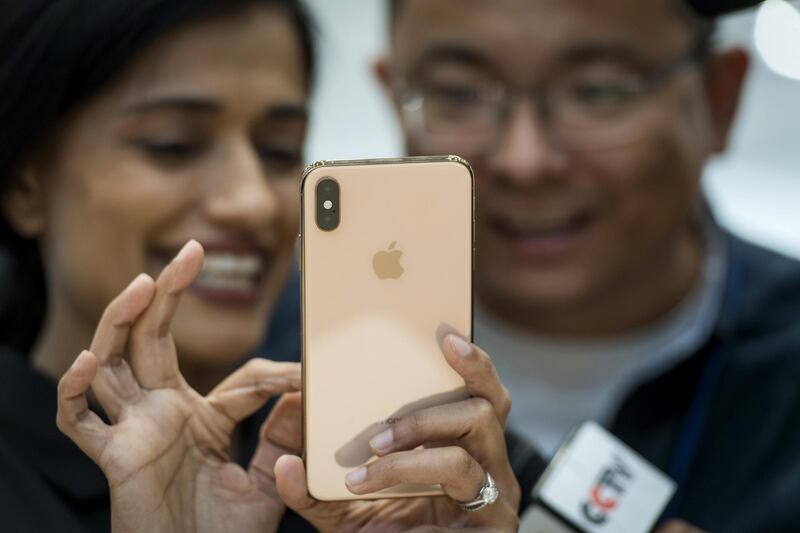 An attendee demonstrates the Apple Inc. iPhone XS Max. David Paul Morris / Bloomberg