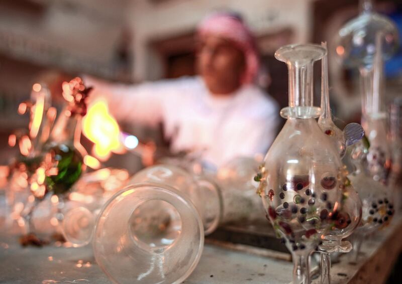 Abu Dhabi, United Arab Emirates, July 23, 2019.  VB:  Photo project at the Heritage Village, Corniche.  Local craftsworkers conduct workshops in traditional metalwork, pottery, glass blowing and Arabic cloak making. --  Noor Ahmad-47, Arabic glass blowing artist busy in his workshop at Heritage Villlage.
Victor Besa/The National
Section:  NA
Reporter: