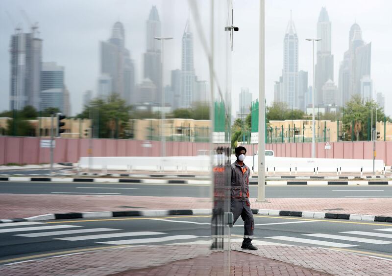 Dubai, United Arab Emirates - Reporter: N/A: Corona. A gentleman walks round the corner with a facemark on near Hessa Street. Monday, March 30th, 2020. Dubai. Chris Whiteoak / The National
