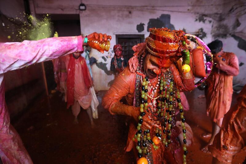 Hindu men from the village of Nandgaon throw colored water on Hindu men from Barsana as they arrive at the Nandgram temple during the Lathmar Holi festival at the Nandgram temple in Nandgaon, Mathura, India, 05 March 2020. EPA